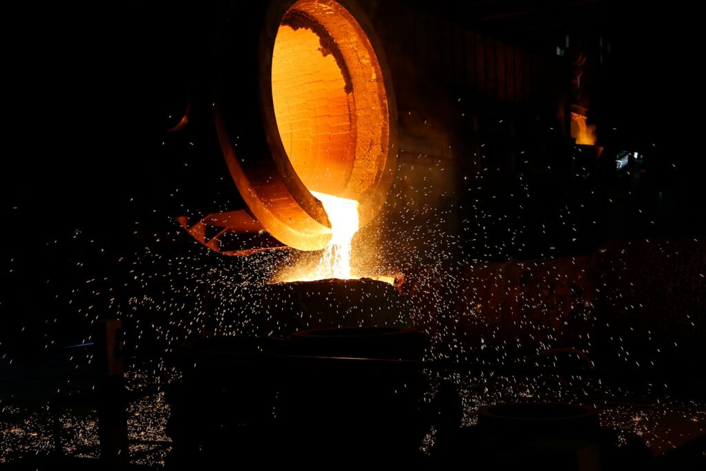 a large piece of metal being poured into a container